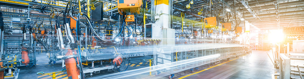 A high-tech automotive factory with numerous robotic arms and machinery assembling vehicles. The sun shines through the windows, illuminating the industrial scene with bright light. The environment is busy and highly automated.