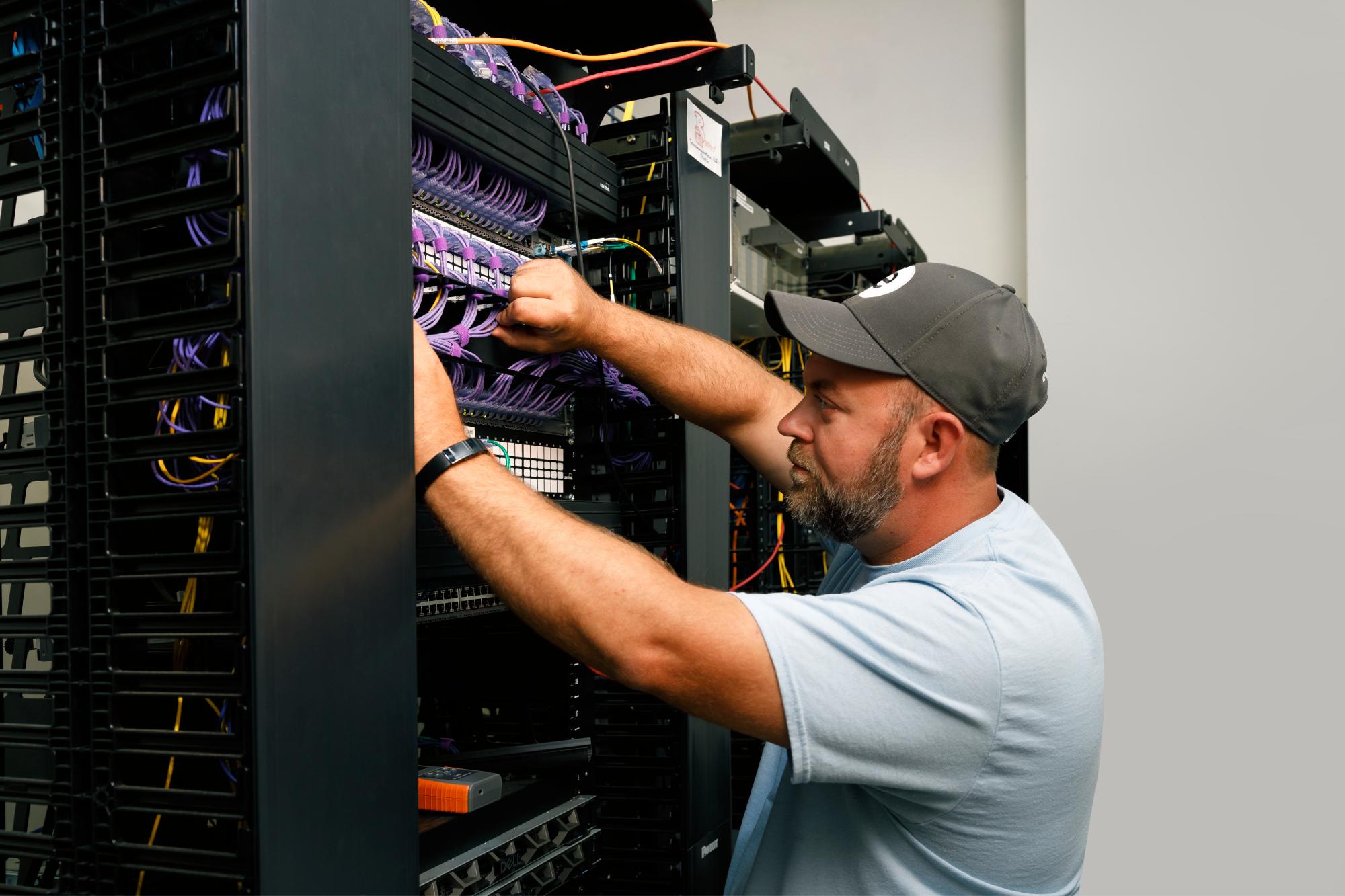 a man working on a server rack
