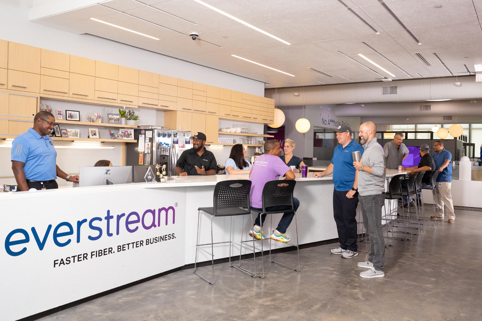 a group of people chatting in the everstream office