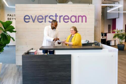 two people looking at a paper at an everstream office desk